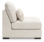 Armless chair corner with light beige fabric, tall back, and striped throw pillow
