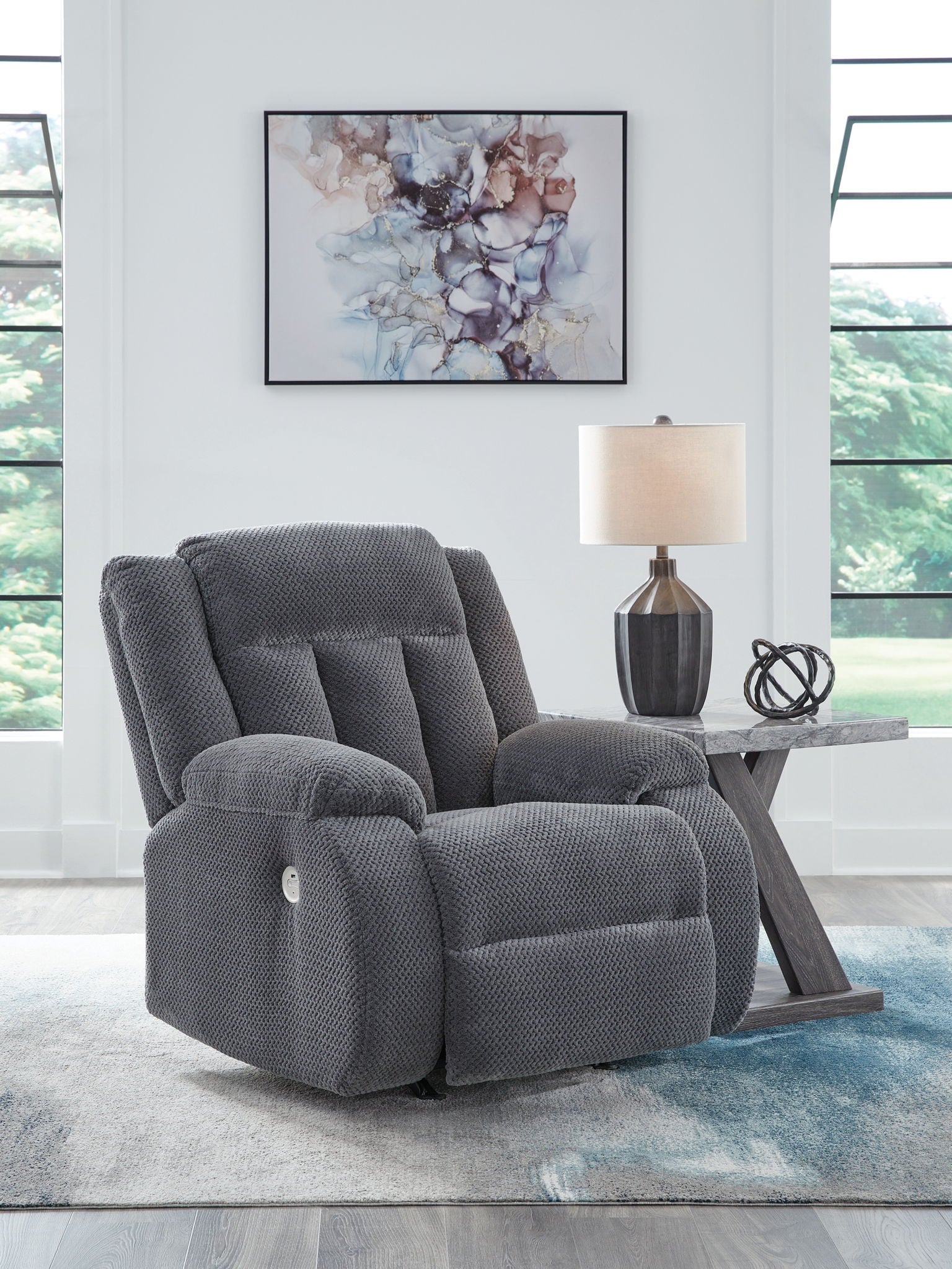 Dark steel-gray fabric power rocker recliner with padded arms and tall back