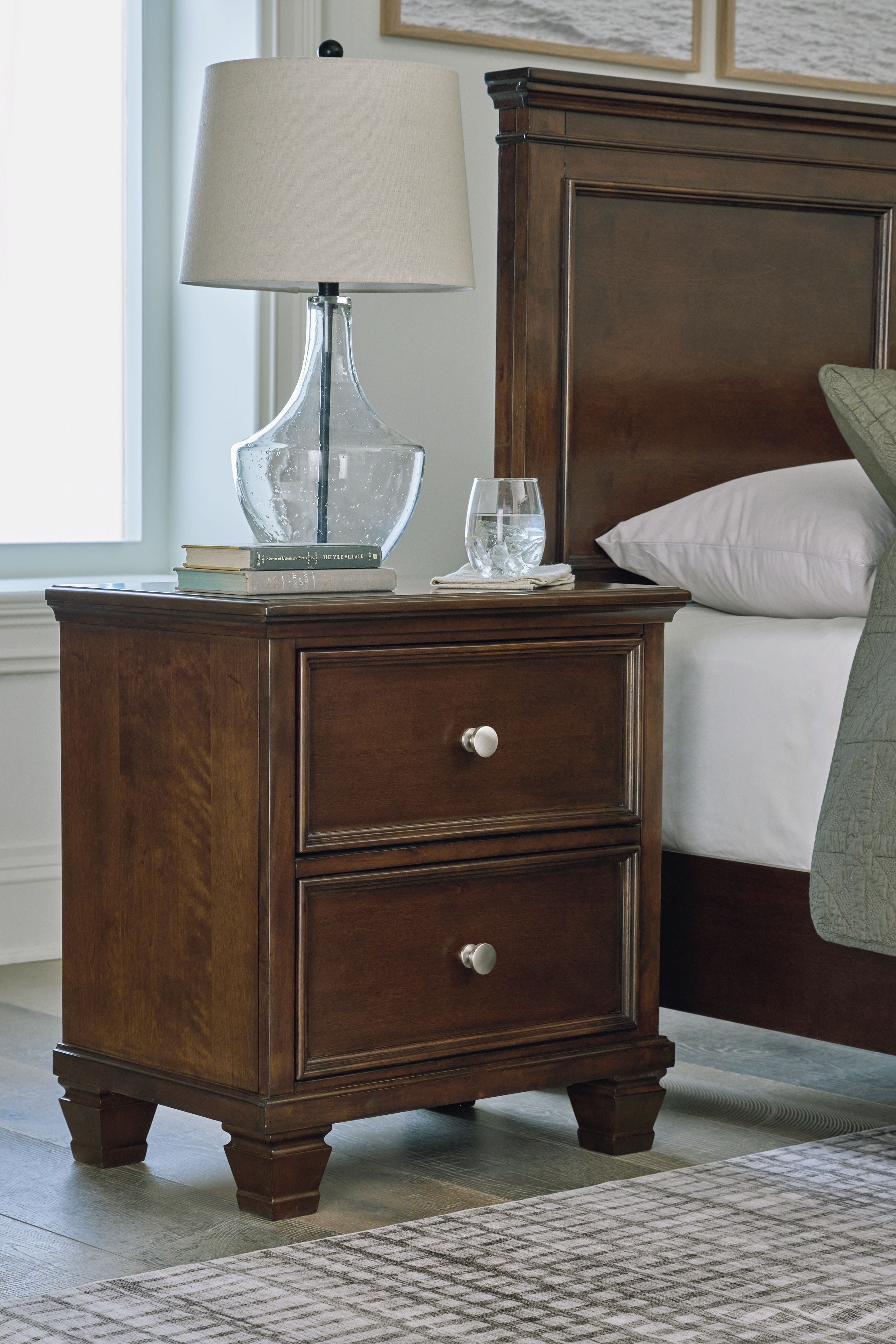 Brown two-drawer nightstand with two drawers and round metal knobs