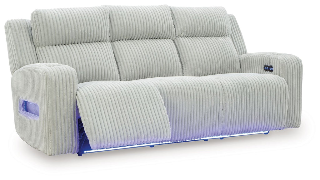 Power reclining sofa with adjustable headrests, light gray ribbed upholstery, reclined seat