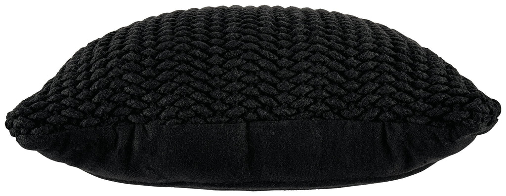 Black knitted pillow with rounded edges and chunky braided texture, side view.