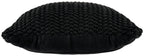 Black knitted pillow with rounded edges and chunky braided texture, side view.