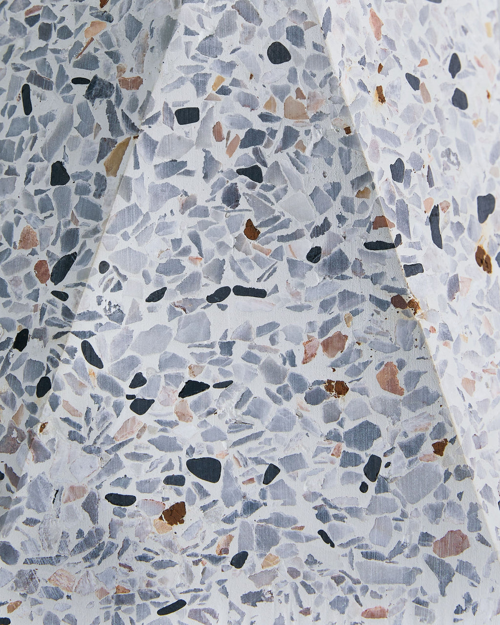 Close view of white terrazzo concrete table lamp base with speckled inlays
