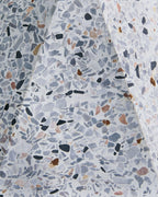 Close view of white terrazzo concrete table lamp base with speckled inlays