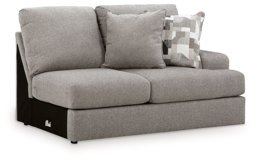 Smoke gray loveseat with two seat cushions, arms, and patterned throw pillow