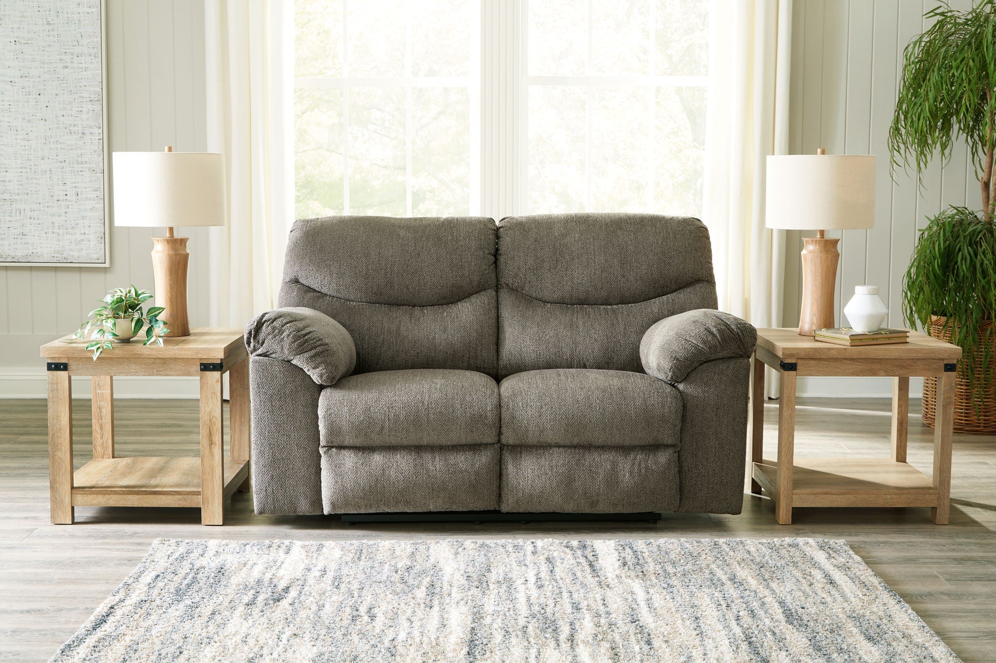 Taupe fabric sofa with two seat sections and rounded, padded armrests