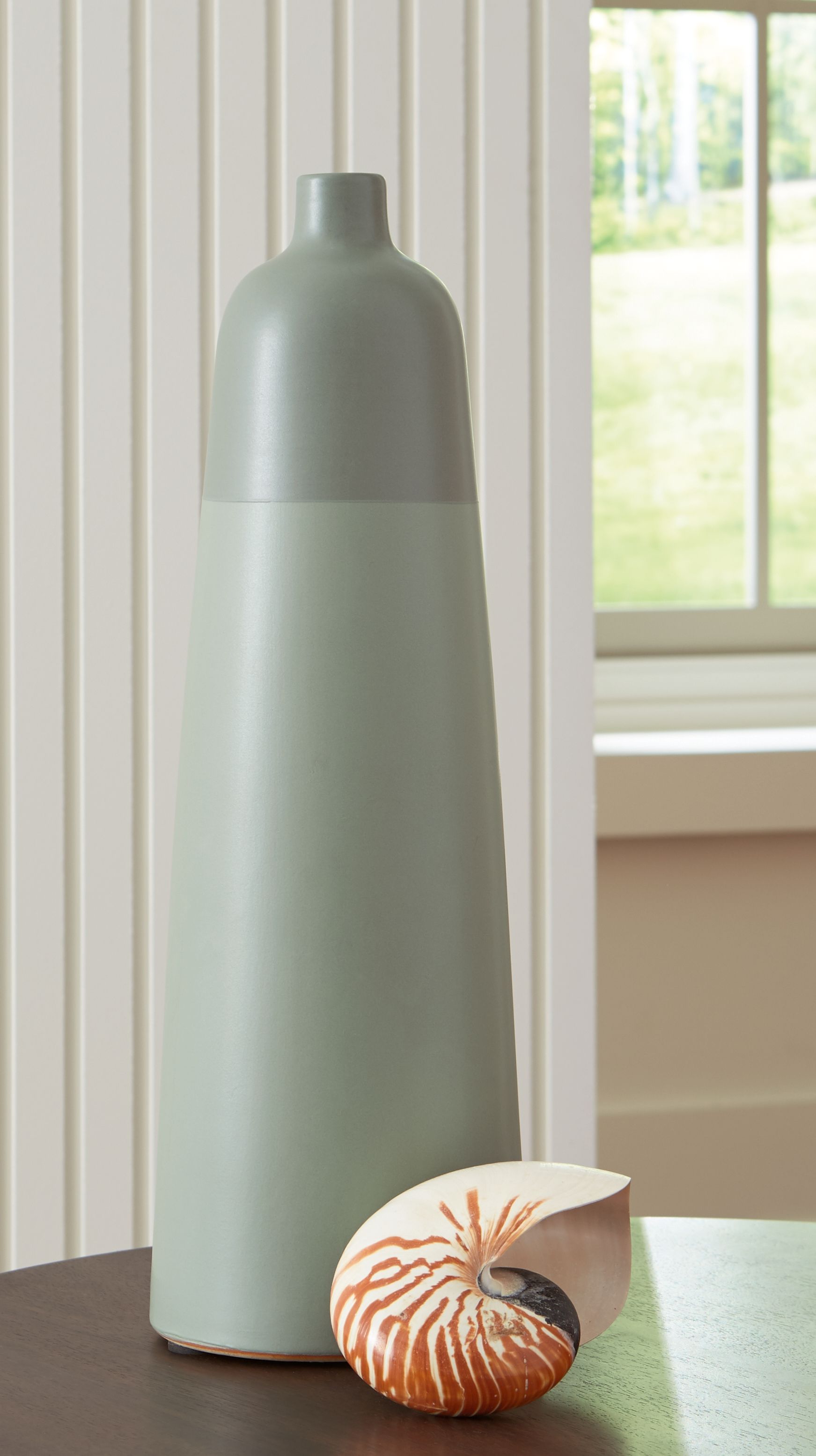 Sage green ceramic vase with flared top and rounded base shape