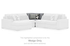 Light-colored sectional wedge with cushions and patterned accent pillows