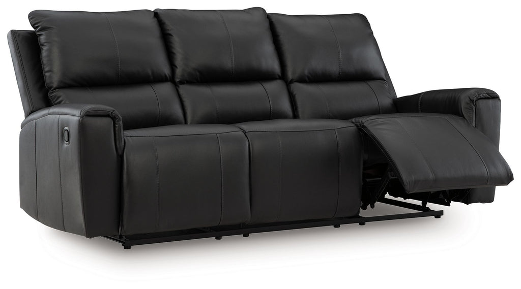 Black reclining sofa with extended footrest and tufted back cushions