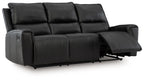 Black reclining sofa with extended footrest and tufted back cushions