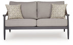 Gray loveseat with two seat cushions and two square hex-pattern throw pillows