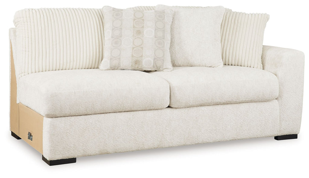 Ivory upholstered loveseat sofa with ribbed back cushions and three throw pillows