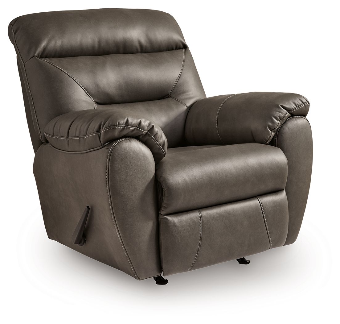 Dark gray rocker recliner with footrest ottoman and cushioned armrest detail
