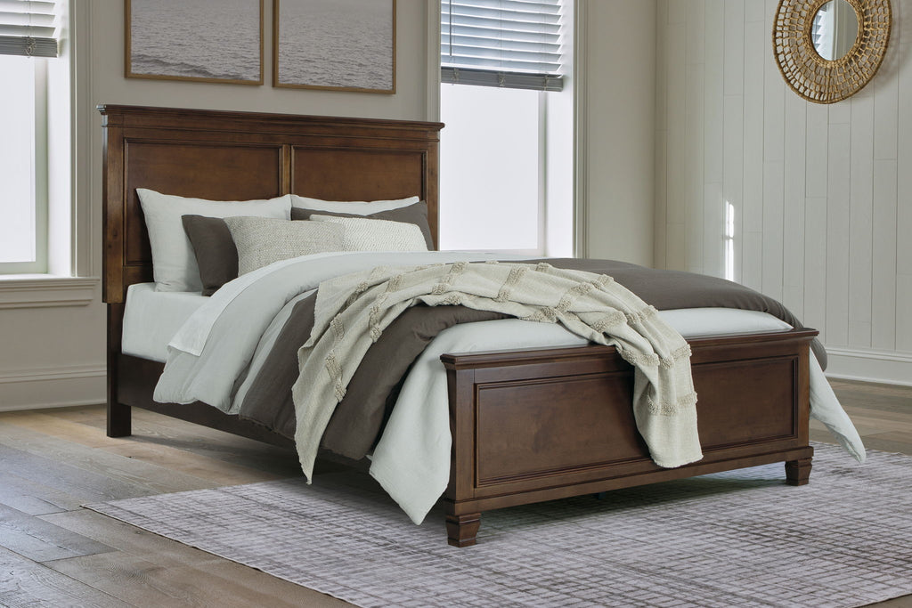 Dark brown panel bed with white sheets, gray pillows, and draped throw blanket.