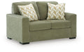 Olive green upholstered loveseat with two patterned accent pillows and square arms