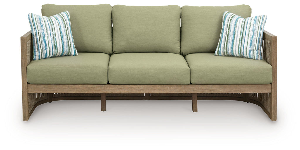 Outdoor sofa with green cushions and two striped pillows, beige slatted armrests