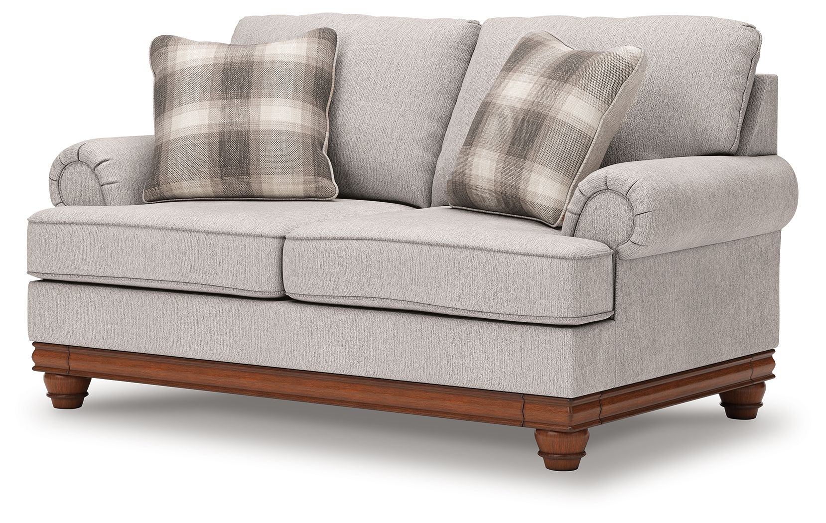 Upholstered loveseat in light sand fabric with plaid throw pillows and rolled arms