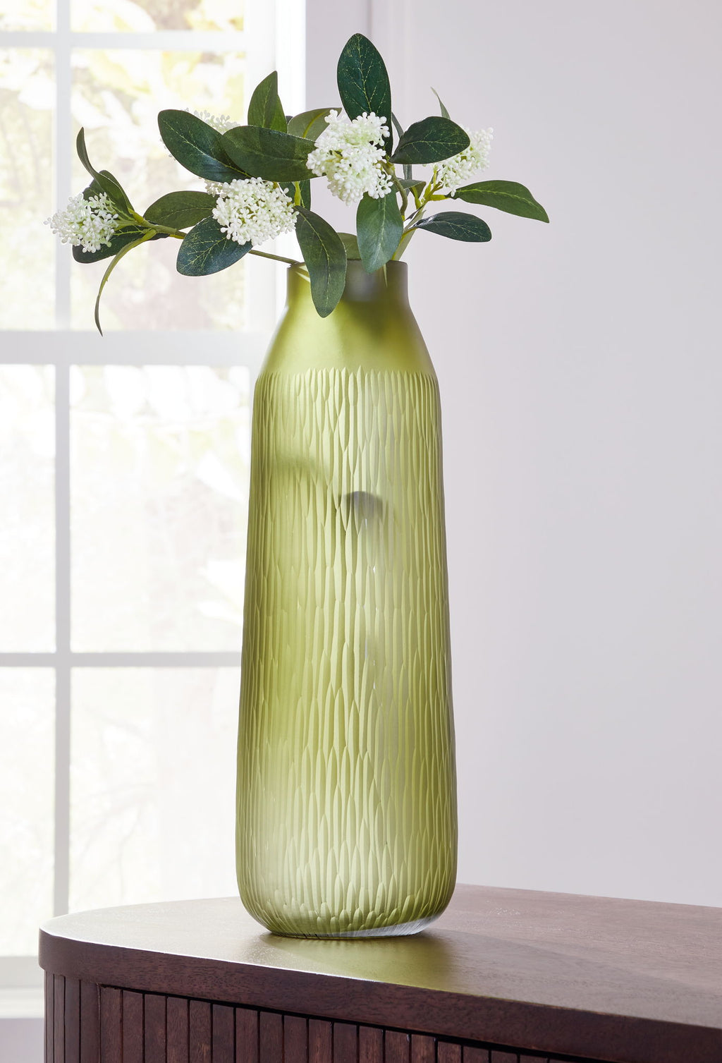 Olive green glass vase with vertical ridges, narrow neck and open top