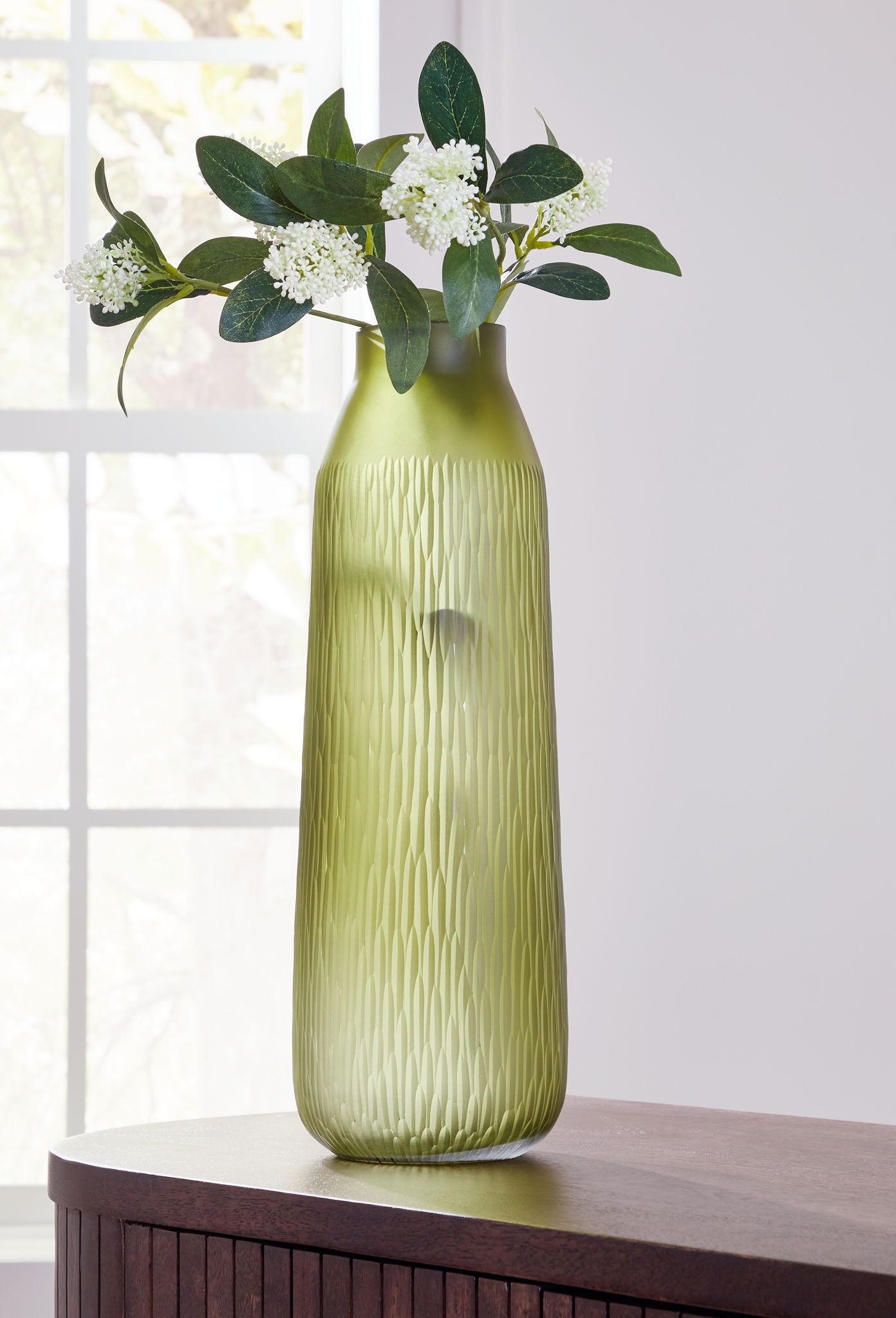 Olive green glass vase with vertical ridges, narrow neck and open top