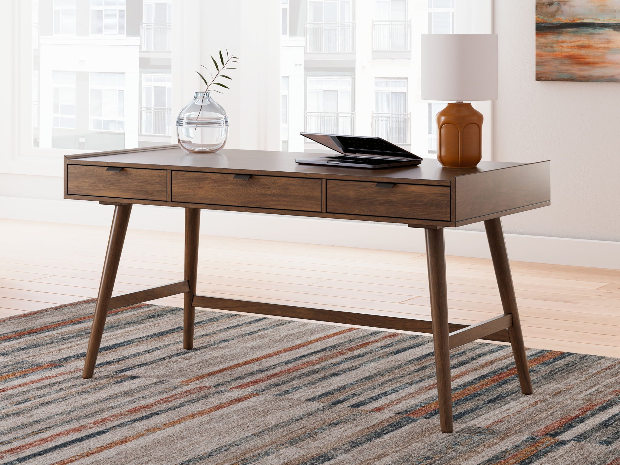 Brown home office desk with three drawers and open center shelf