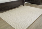 Cream rug with tonal wavy lines pattern and thick, textured border