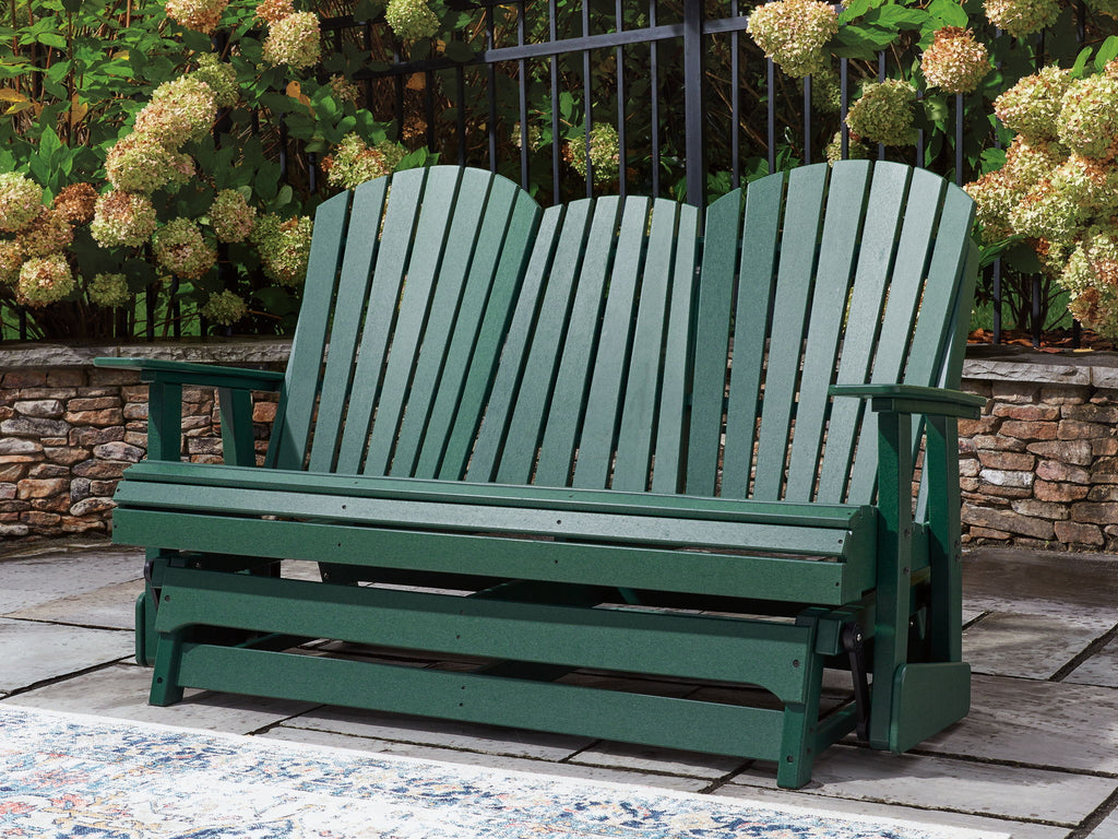 Green wooden loveseat glider with slatted back and bench seat for outdoor use