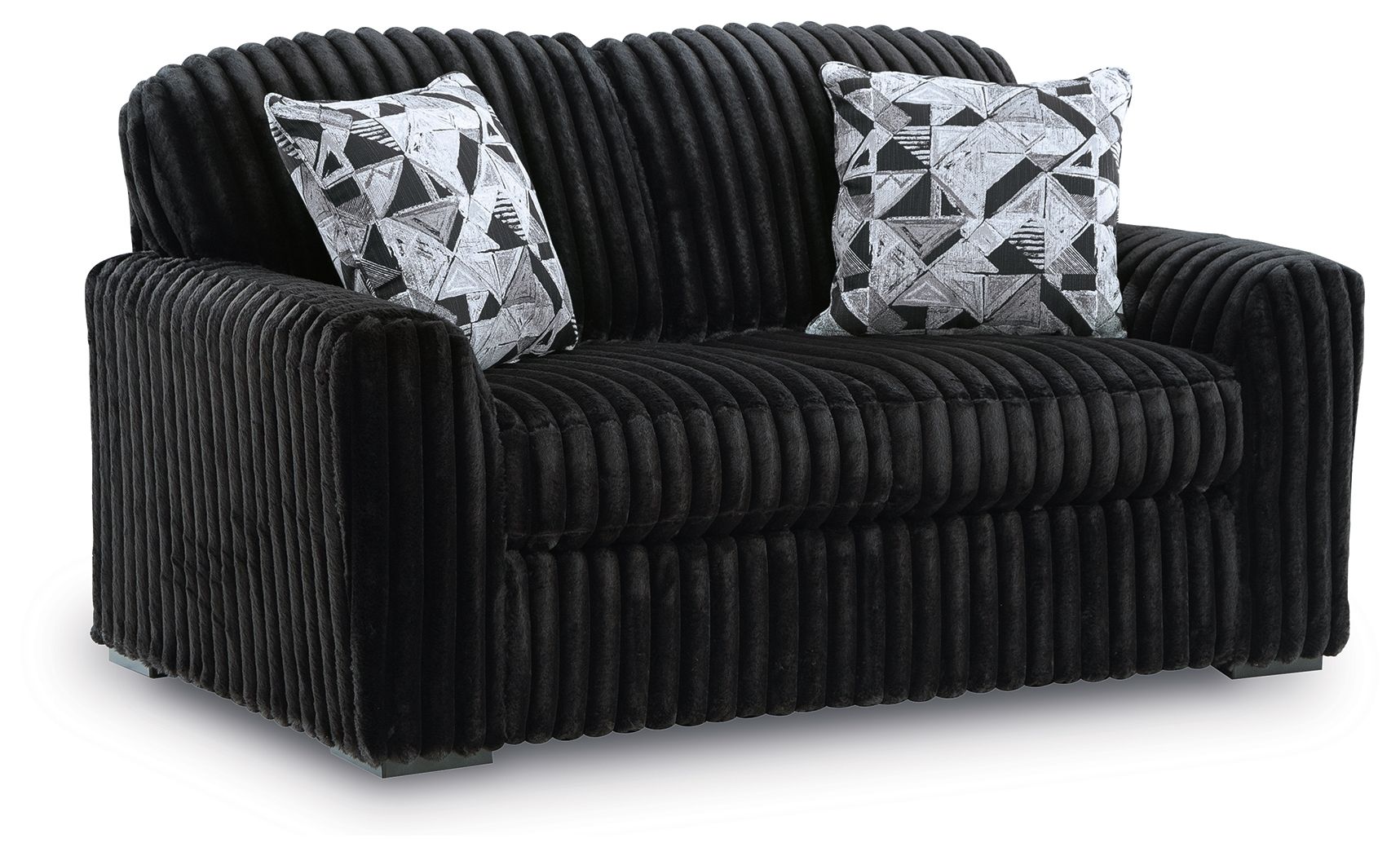 Black corduroy loveseat with two black-and-white geometric throw pillows