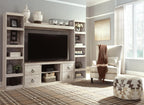 Whitewash entertainment center with TV console, open shelves, and drawer storage
