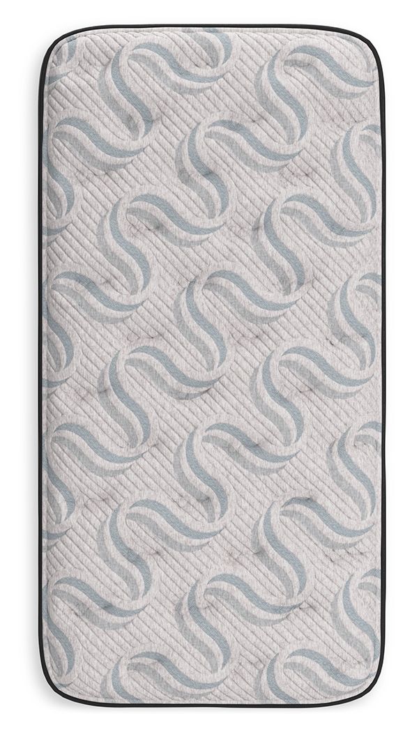 Gray mattress cover with wavy quilted pattern and black fabric edging