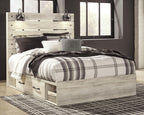 Beige panel bed with side drawers and plaid bedding with pillows