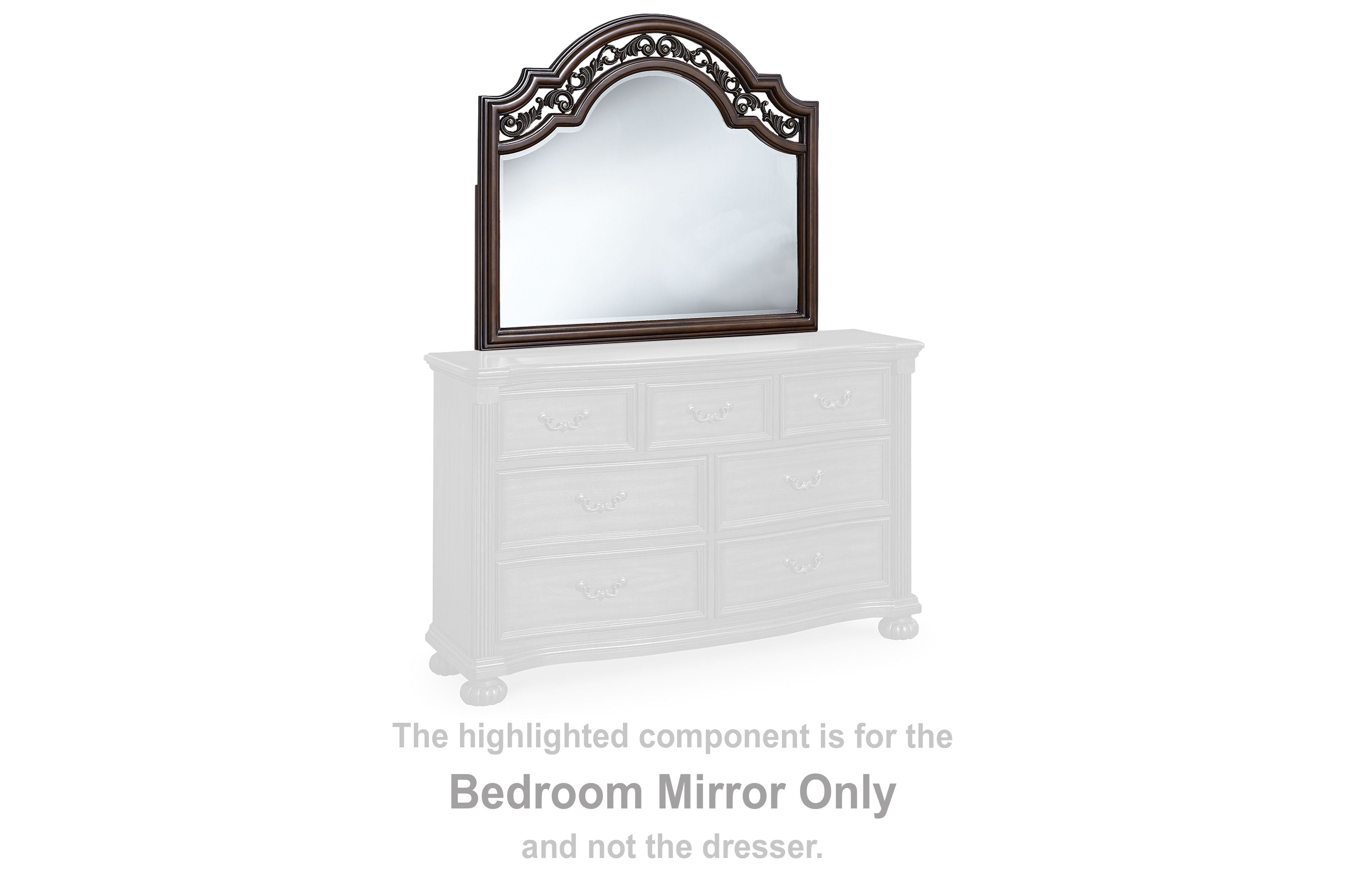 Arched brown bedroom mirror on white dresser with ornate carved frame