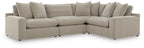 Light gray sectional sofa with deep seating, square arms, and back cushions along the curve.
