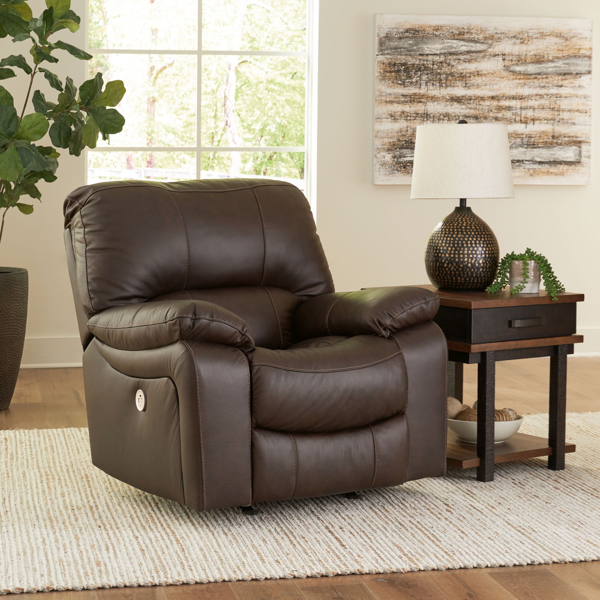 Dark brown rocker recliner chair with tufted back cushions and wide padded arms