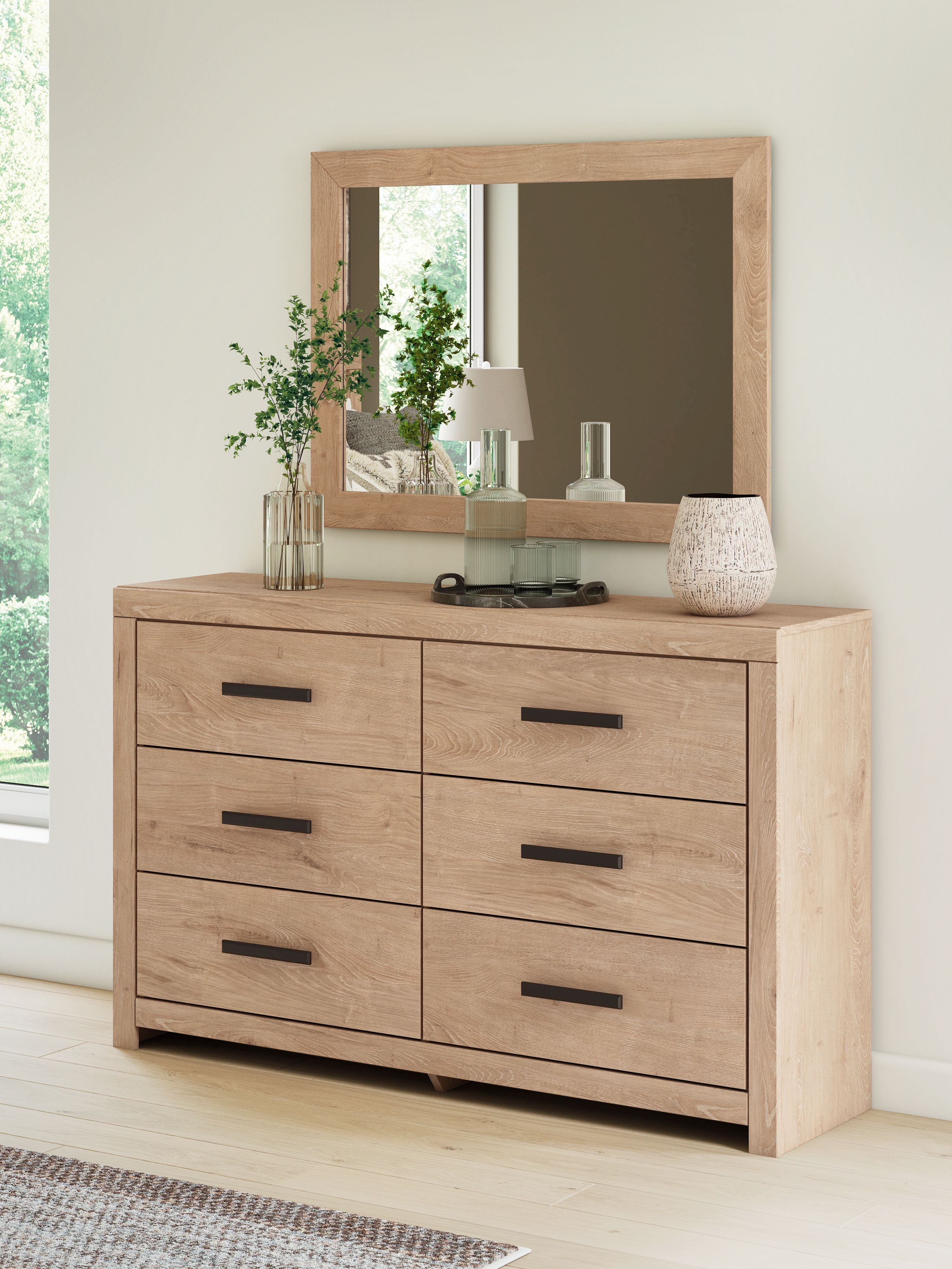 Tan dresser with mirror and six drawers, black bar handles