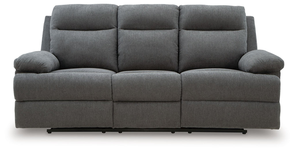 Dark gray reclining sofa with three seat sections and tufted back cushions
