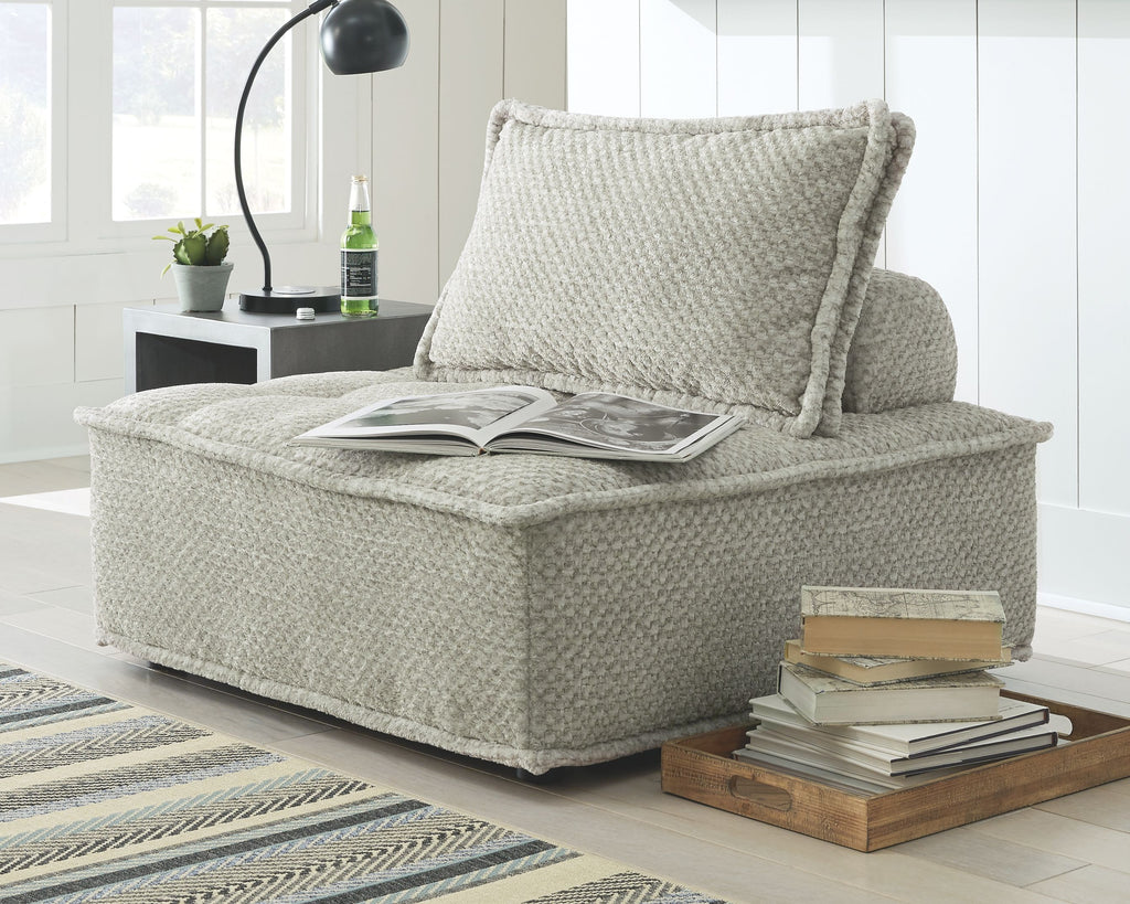 Light beige textured accent chair with high back cushion and wide chaise seat
