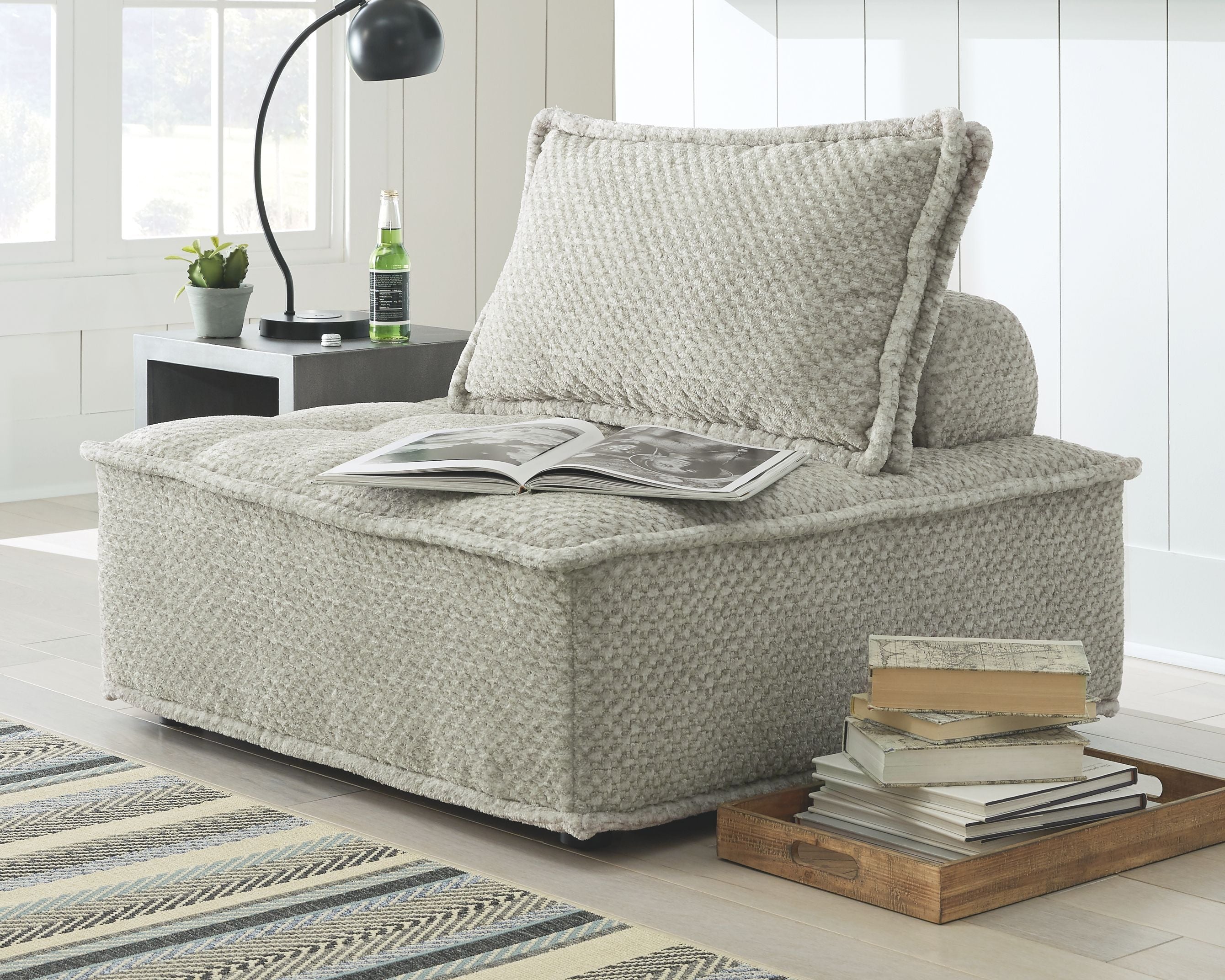 Light beige textured accent chair with high back cushion and wide chaise seat