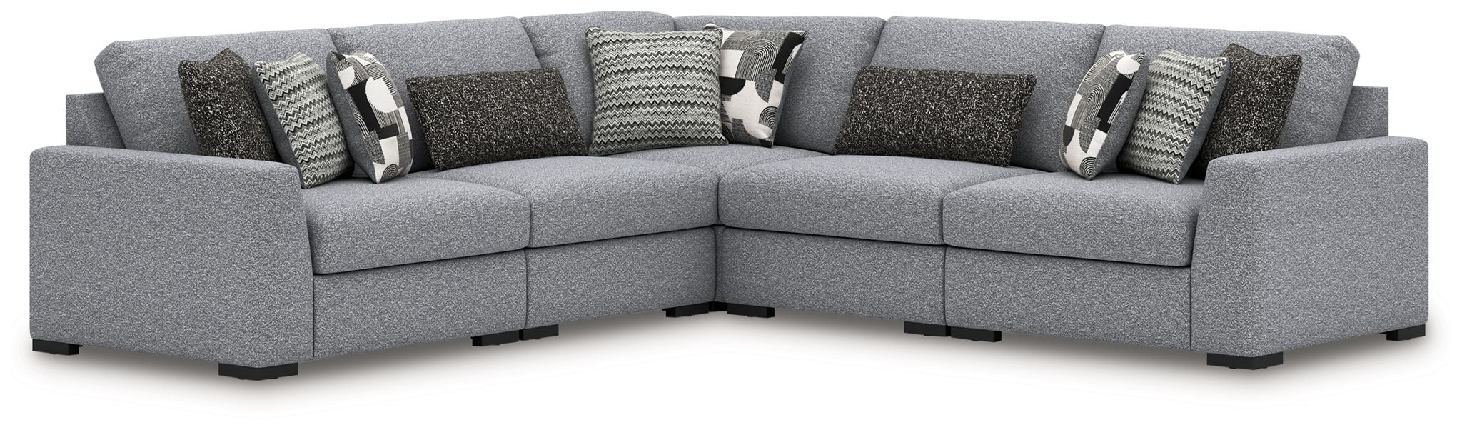 Gray sectional sofa with corner chaise and multiple patterned throw pillows