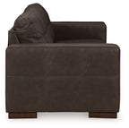 Dark brown fabric sofa with arched backrest and visible stitching seams