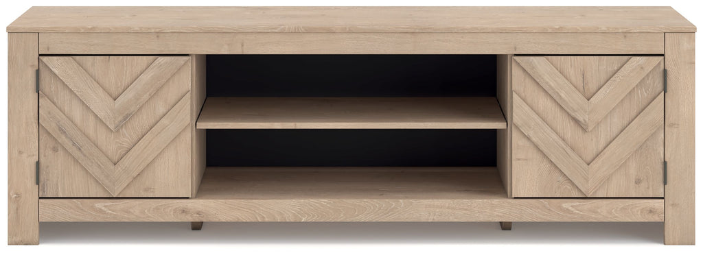 Beige TV stand with chevron cabinet doors and open center shelves