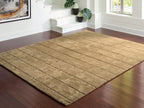 Light brown rug with geometric block motif and thin stitched detail border