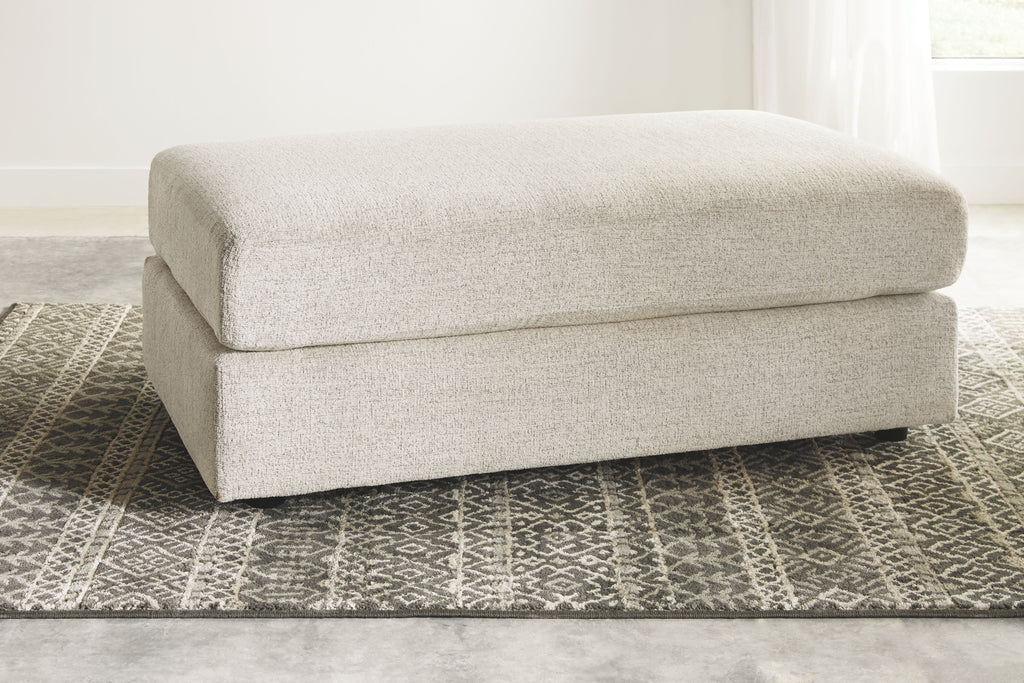 Beige fabric accent ottoman with padded top cushion