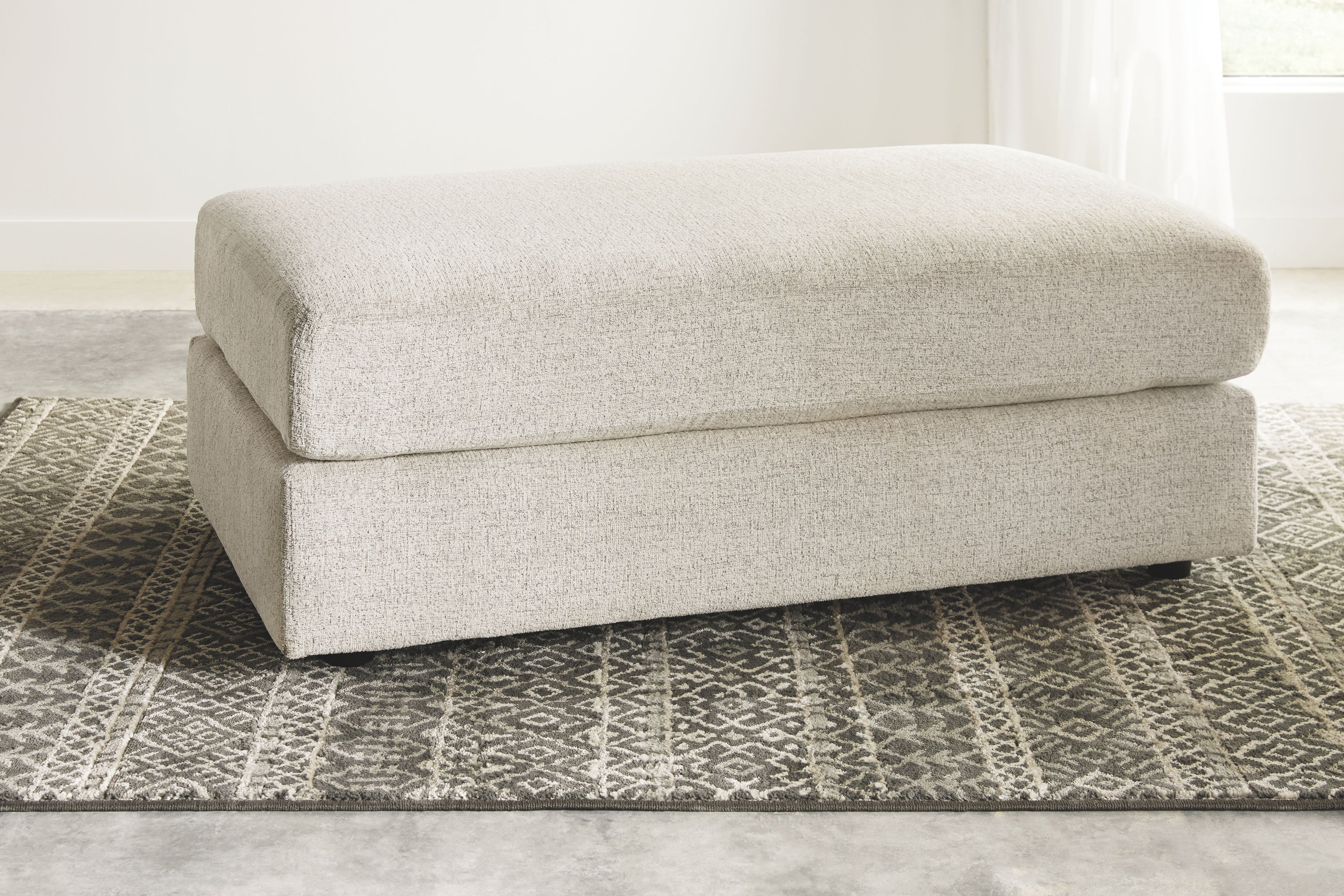 Beige fabric accent ottoman with padded top cushion