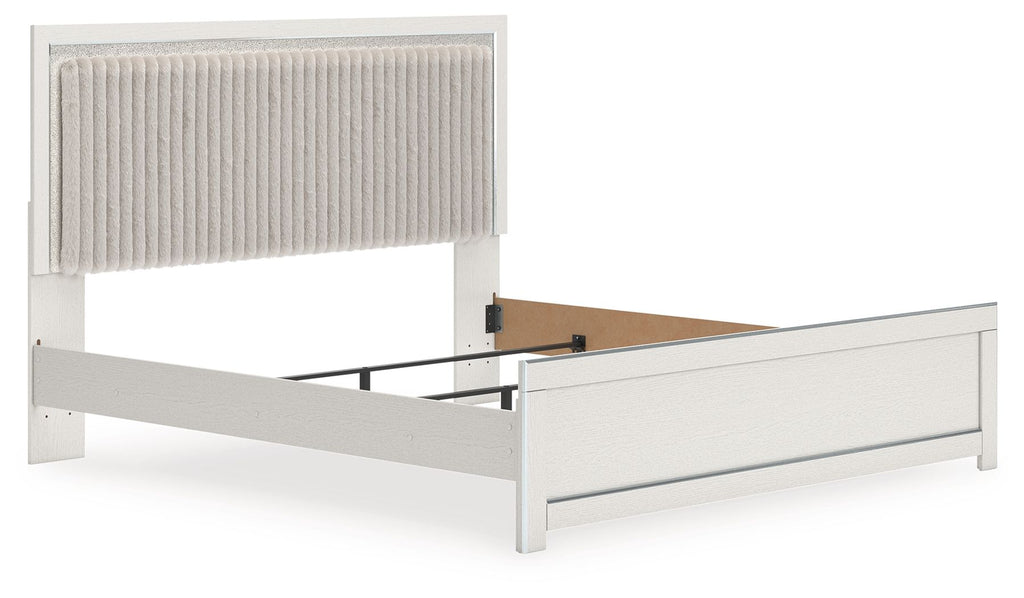 Upholstered panel bed with light upholstered headboard and white side rails, no bedding