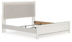 Upholstered panel bed with light upholstered headboard and white side rails, no bedding