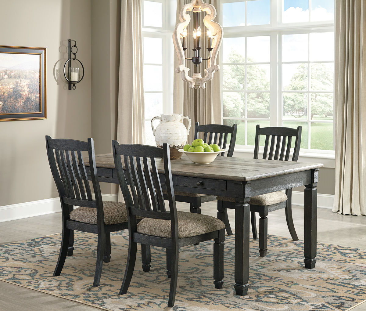 Dark gray dining table with four slat-back chairs and upholstered seat cushions