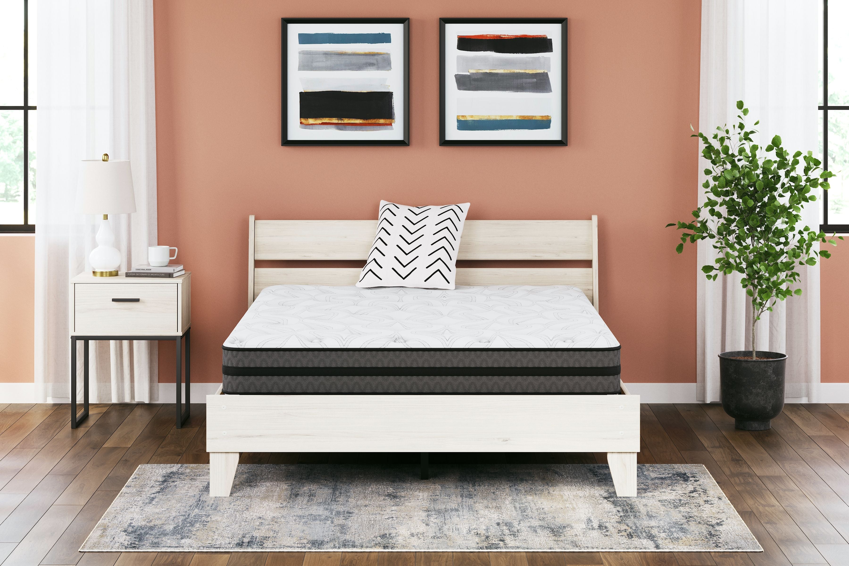 Hybrid mattress with white quilted top on a white platform bed frame