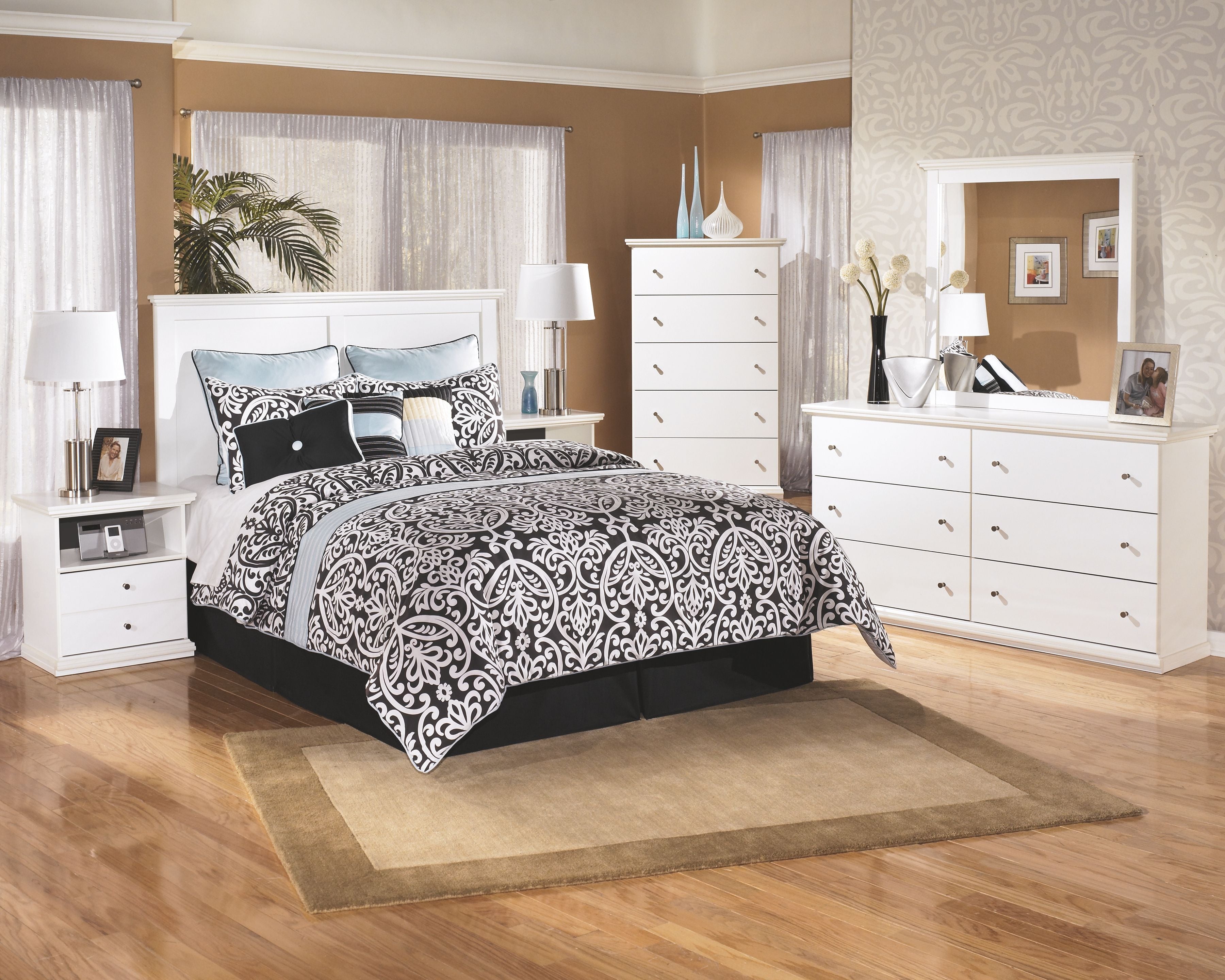 White five-drawer chest with metal drawer knobs and decorative top trim