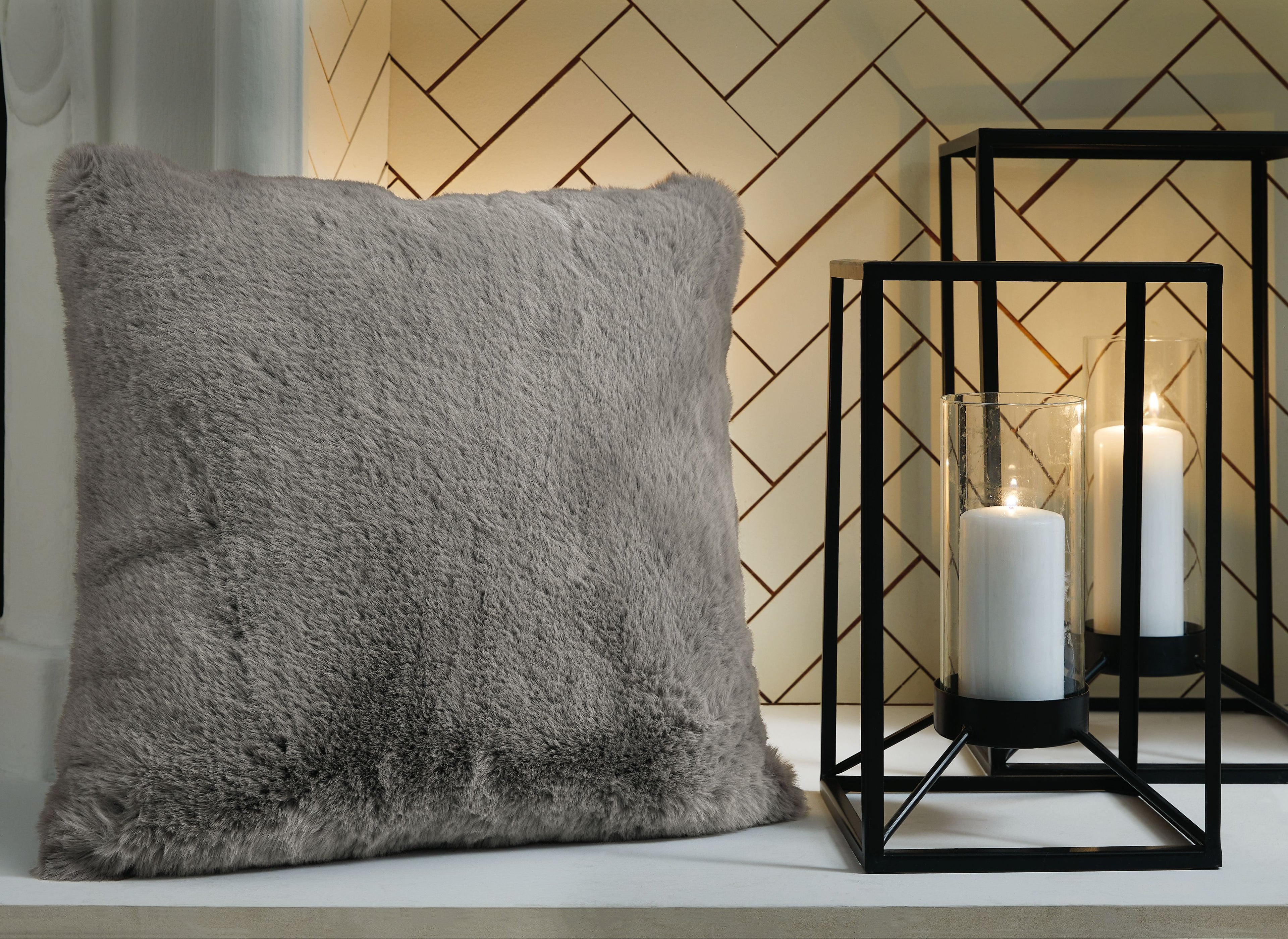 Gray faux fur pillow, square with plush shag texture.