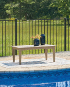 White rectangular cocktail table with four legs and decorative items on top